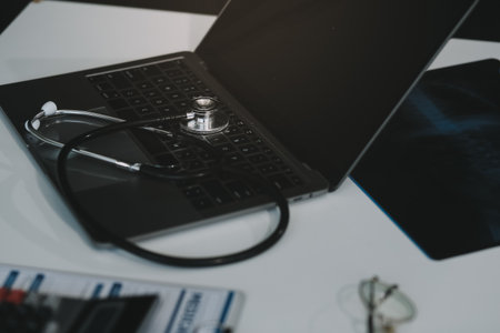 Stethoscope with prescription clipboard and Laptop ,Doctor working an Exam, Healthcare and medical concept,test results in background,vintage color,selective focusの写真素材
