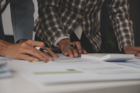 Team of business people working together in the meeting room office, teamwork background charts and...