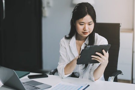 Businesswoman working at office with documents on desk, doing planning analyzing the financial...