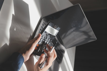 businessman working on desk office with using a calculator to calculate the numbers, finance...
