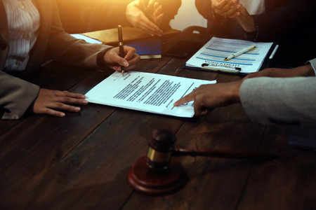 Judge gavel with Justice lawyers having team meeting at law firm background. Concepts of Law and Legal services.の写真素材