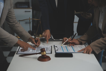 Judge gavel with Justice lawyers having team meeting at law firm background. Concepts of Law and Legal services.の写真素材