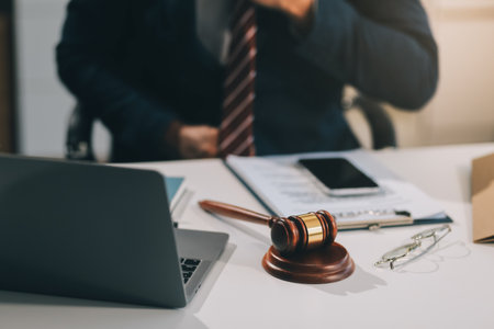 Male lawyer working with contract papers and wooden gavel on tabel in courtroom. justice and law...