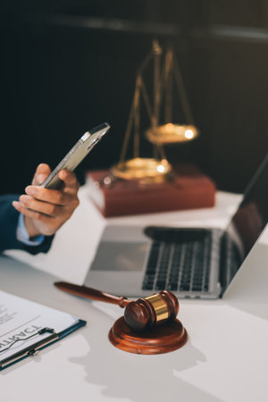 Male lawyer working with contract papers and wooden gavel on tabel in courtroom. justice and law...
