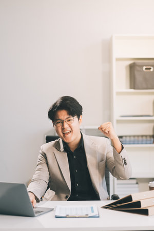 Video call online meeting asian businessman looking web camera and having fun talking and gesturing, man working inside office sharing plans with partners and colleagues, boss in shirt and glasses.の写真素材