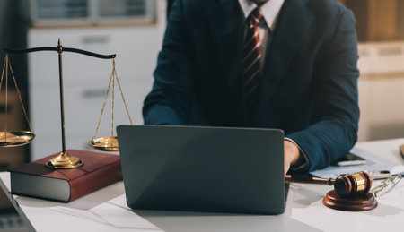 Male lawyer working with contract papers and wooden gavel on tabel in courtroom. justice and law ,attorney, court judge, concept.の写真素材