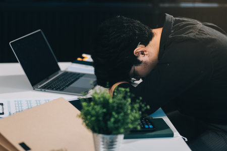 Frustrated Asian young businessman worker working on table in office. Busy employee worker people...