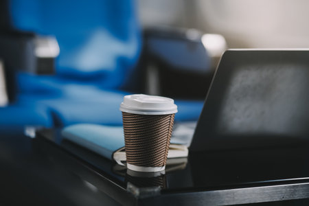 Asian businessman enjoying enjoys a coffee comfortable flight while sitting in the airplane cabin, Passengers near the window.の写真素材