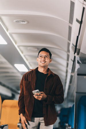 Low Section of Passenger Businessman Walking with Suitcase at the Entrance Walkway in Airport. Focus on Luggage. Low Angle Viewの写真素材