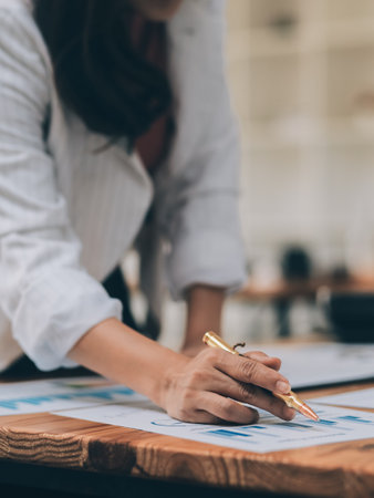 Happy young asian businesswoman sitting on her workplace in the office. Young woman working at laptop in the office.の写真素材