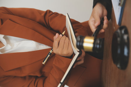 Lawyer, legal advisor, businessman brainstorming information on agreement details Business contracts in legal processing books for accuracy in contract documents. joint financial investment.の写真素材