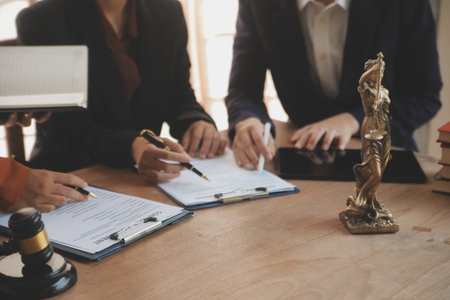 Lawyer, legal advisor, businessman brainstorming information on agreement details Business contracts in legal processing books for accuracy in contract documents. joint financial investment.の写真素材