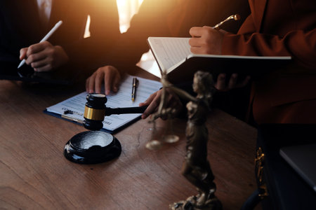 Lawyer, legal advisor, businessman brainstorming information on agreement details Business contracts in legal processing books for accuracy in contract documents. joint financial investment.の写真素材