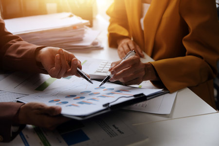 Team of business people working together in the meeting room office, teamwork background charts and graphs banner, double exposure successful teamwork,business planning concept.の写真素材