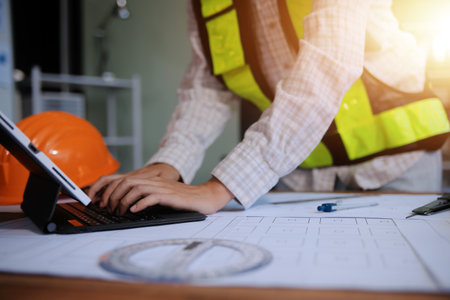 engineer people meeting working and pointing at a blueprint in office for discussing. Engineering tools and construction conceptの写真素材