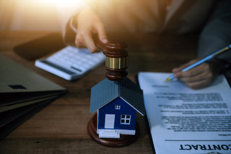 Real Estate Law, Home Insurance, property Tax, Auction and Bidding concepts. small toy house model...
