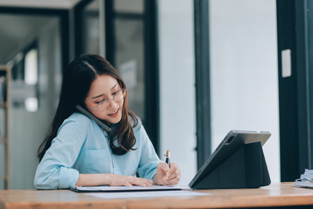 Asian woman working at the office. woman using laptop computer on desk at officeの写真素材