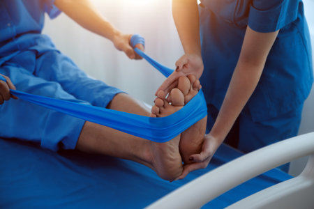 Professional orthopedist examining the little patient's leg in the clinic. Patient at the...