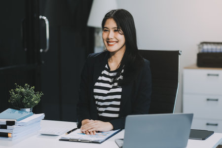 Young pretty business woman with notebook in the office