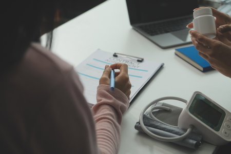 Doctor and patient discussing something while sitting at the table . Medicine and health care concept. Doctor and patientの写真素材