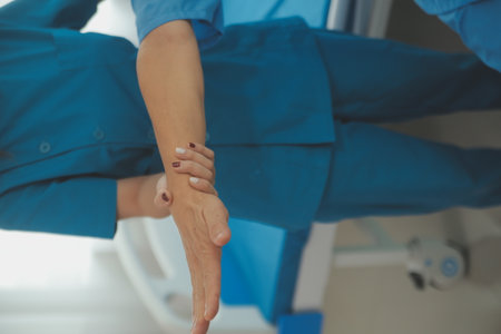 Physiotherapist man giving exercise with dumbbell treatment About Arm and Shoulder of athlete male patient Physical therapy conceptの写真素材