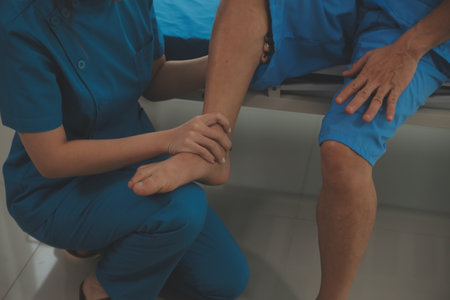 Physical therapists work with patients in close-up clinics. The concept of rehabilitation of physical health, the doctor gives advice to the patient. Ankle problems and muscle injuriesの写真素材
