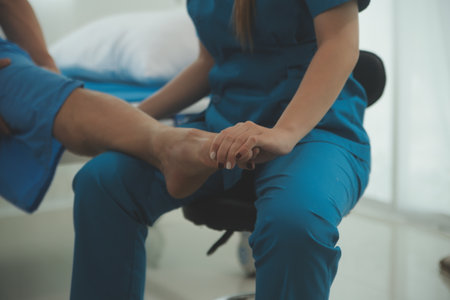 Physical therapists work with patients in close-up clinics. The concept of rehabilitation of physical health, the doctor gives advice to the patient. Ankle problems and muscle injuriesの写真素材