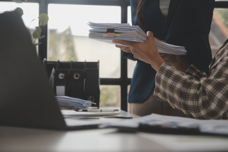Group of confident business people point to graphs and charts to analyze market data, balance sheet,...