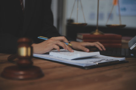 Judge gavel with Justice lawyers having team meeting at law firm background. Concepts of Law and...