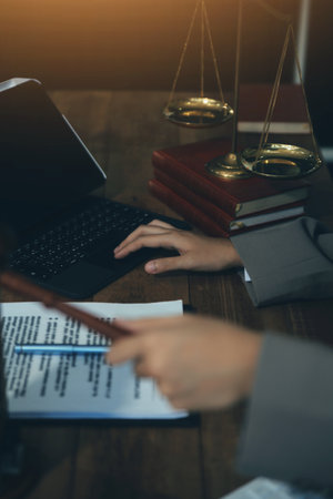 Real Estate Law, Home Insurance, property Tax, Auction and Bidding concepts. small toy house model with gavel justice hammer on desk in courthouse.の写真素材