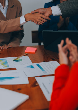 Group of business workers smiling happy and confident. Working together with smile on face shaking hands at the officeの写真素材