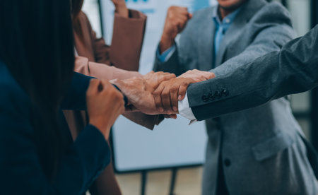 Business people join hand together during their meeting