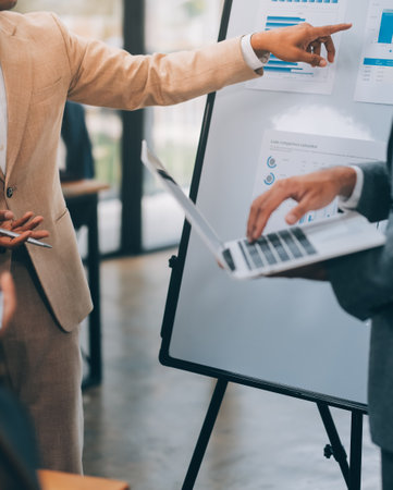Young Businesspeople Working with Laptop in Modern Office. Office Workers at Work. Communication and Discussion at Work Concepts. Business Concept. Businessman and Businesswoman Concepts.の写真素材