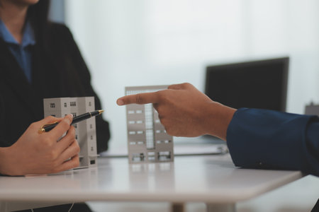 Sale representative offer house purchase contract to buy a house or apartment or discussing about loans and interest ratesの写真素材