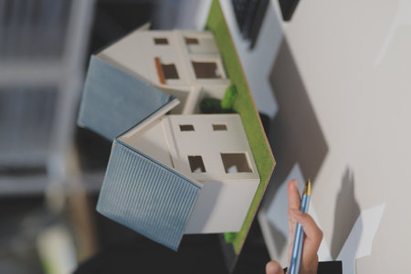Real estate agents explain models of housing estates in projects to elaborate to clients, explaining...