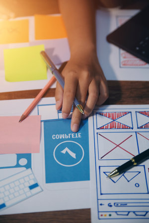 The designer team is designing the uxui system to make the uxui system work well on new phones and support system updates. Website development concept UI UX front end designerの写真素材