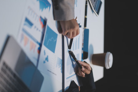 Close up of Business team analyzing income charts and graphs with modern laptop computer. Business analysis and strategy concept.の写真素材