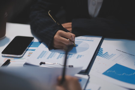 Close up of Business team analyzing income charts and graphs with modern laptop computer. Business analysis and strategy concept.の写真素材