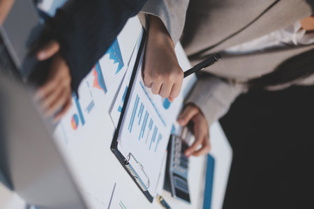Close up of Business team analyzing income charts and graphs with modern laptop computer. Business analysis and strategy concept.の写真素材