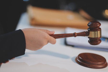 Judge gavel with Justice lawyers having team meeting at law firm background. Concepts of Law and Legal services.の写真素材