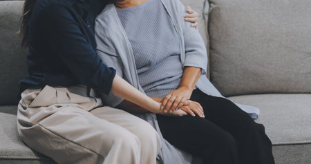 Sad teen granddaughter hugging depressed mature grandmother, giving support, help, comforting,...