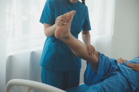 Physical therapists work with patients in close-up clinics. The concept of rehabilitation of physical health, the doctor gives advice to the patient. Ankle problems and muscle injuriesの写真素材