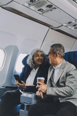 Happy elderly senior couple of travelers with suitcase in airportの写真素材