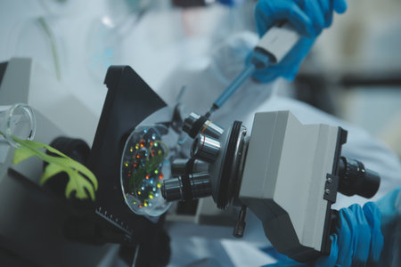 Scientist cutting plant tissue culture in petri dish, performing laboratory experiments. Small plant...