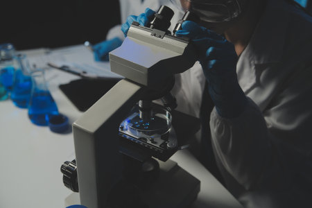 professional chemist woman laboratory using scientific microscope for science research, chemistry...