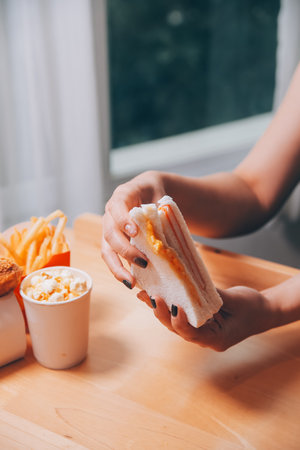 Asian healthy woman have breakfast with sandwich in morning