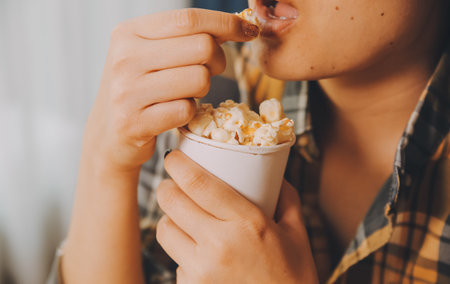 A woman holding a bowl of popcornの写真素材