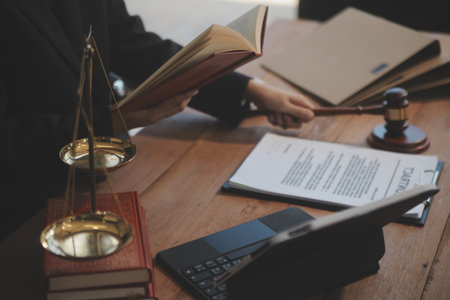 Judge gavel with Justice lawyers having team meeting at law firm background. Concepts of Law and...