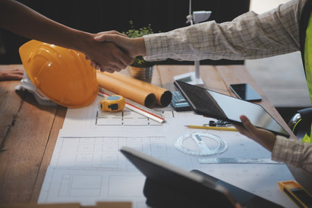 Architect men making handshake in construction site. Employee or worker shake hands to employer man...