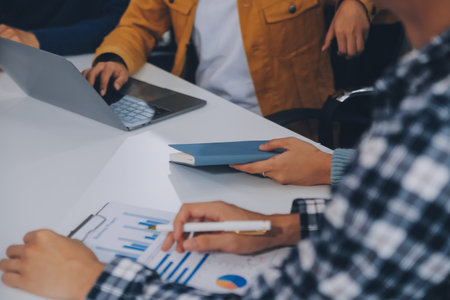 Young friends doing school assignment together at homeの写真素材